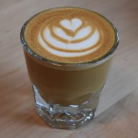 A cortado served in a glass.